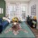 Model living room at our apartments in Berry Hill, TN, featuring a blue couch, doors to the porch, and 70s decor.