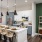 Model kitchen at our apartments in Berry Hill, TN, featuring wood grain floor paneling and a kitchen island.